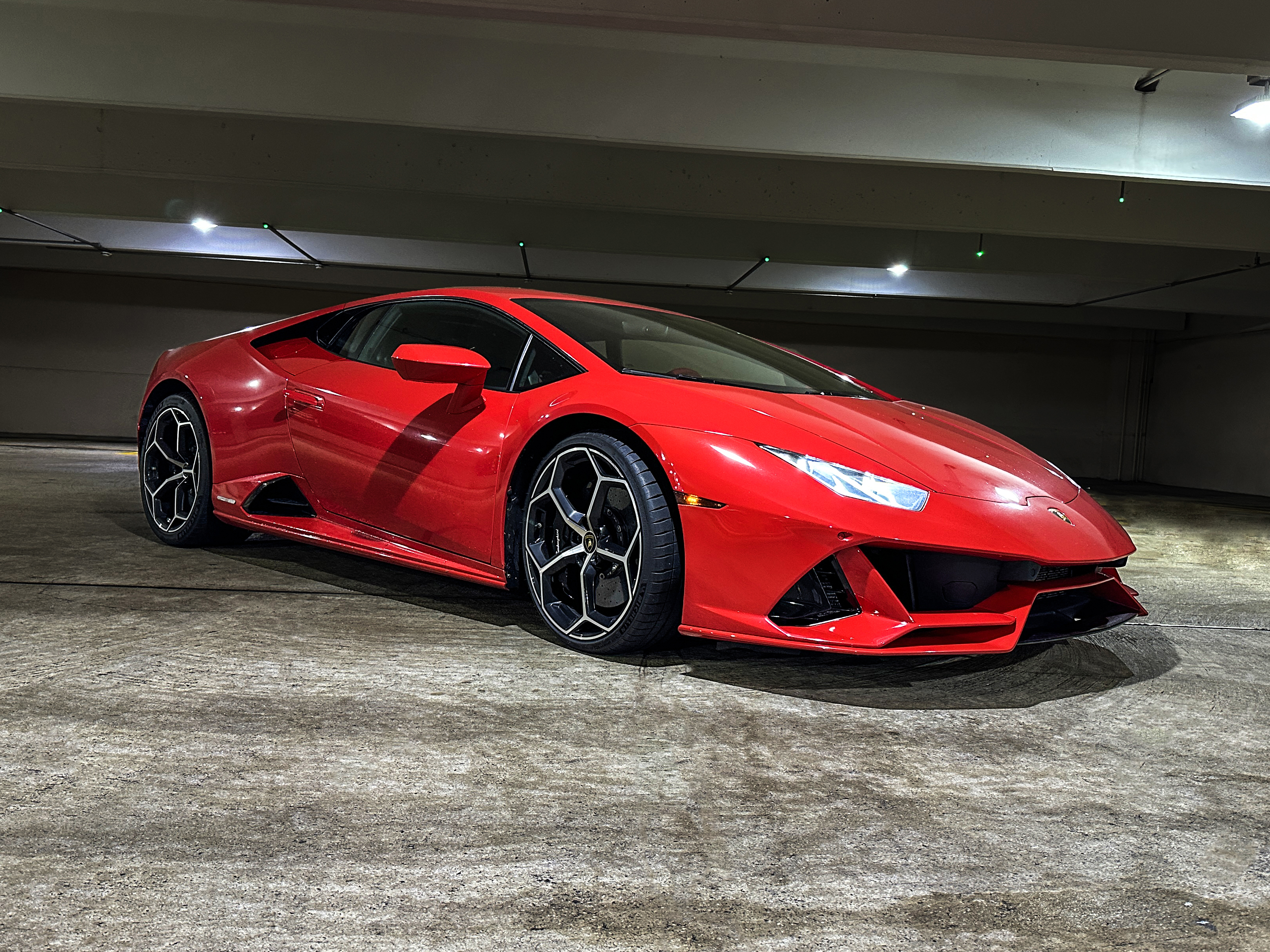 red 2020 Lamborghini Huracan EVO in a parking garage