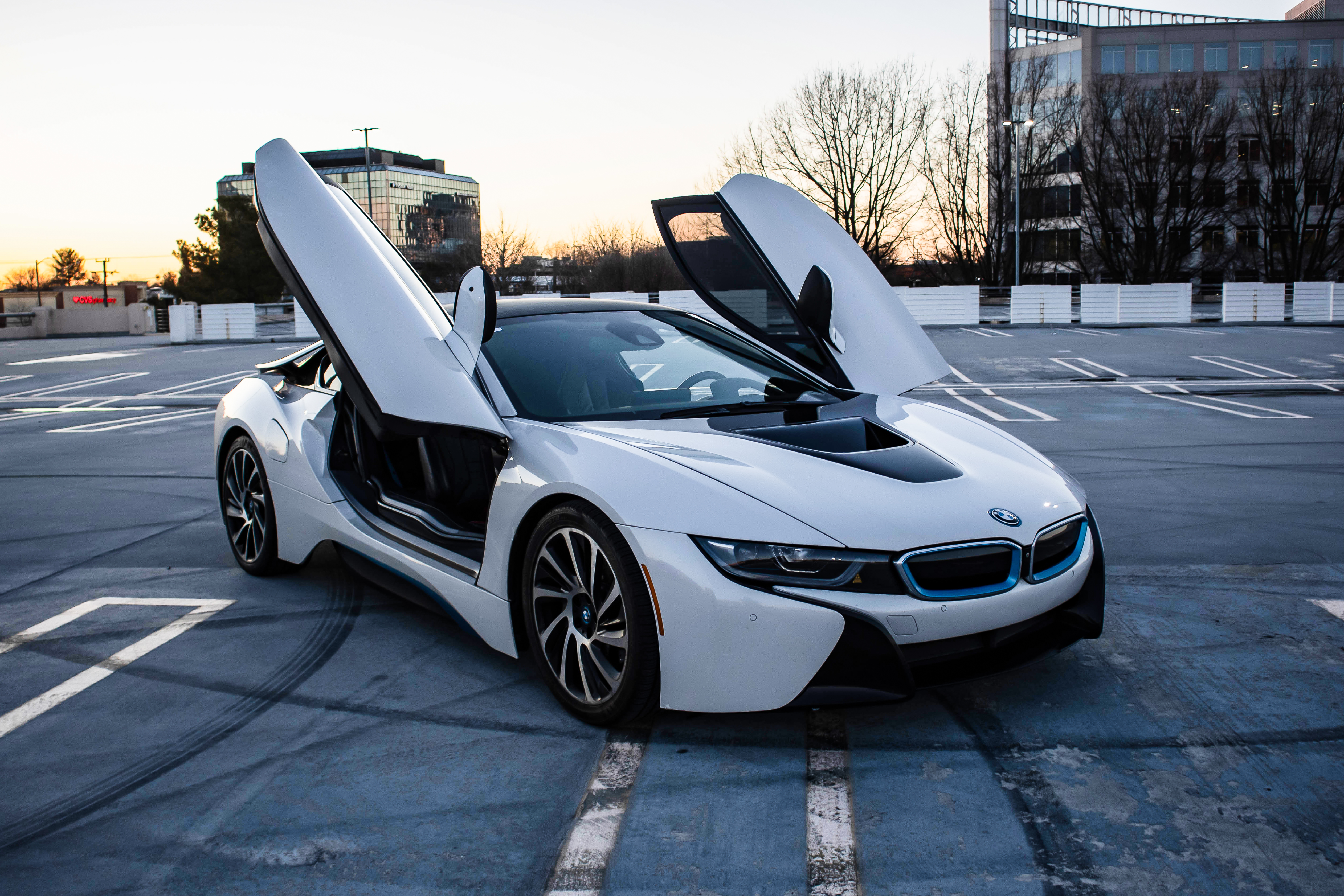 white BMW i8 coupe with black trim and both butterfly doors open